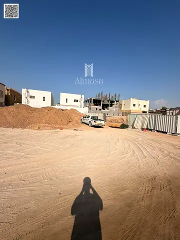 Prime land for sale in Al Zahia, Ajman, on a main road and alley.