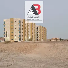 commercial land for sale in masfout \\ prime location \\ next to hospital