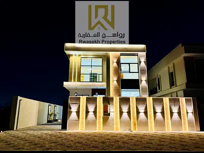 Villa for sale in Ajman, Al Helio 1 area, opposite all services on Sheikh Mohammed bin Zayed Road  4 master bedrooms, a hall, a sitting room, and a ki