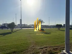 Corner commercial plot for sale in Al-Hawshi, Al-Badi'a suburb, Sharjah. Freehold ownership for 
