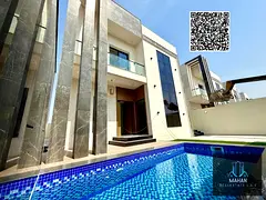 A luxurious modern villa for sale in Al Helio 2, Ajman, featuring a stylish contemporary design and
