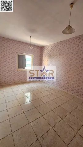 A room and a hall for annual rent in Ajman, spacious with a balcony.