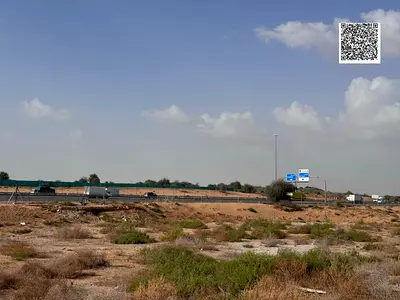 Land for sale in Ajman, Al Zahiyah area. Residential/commercial permit for ground floor + 4 floors. Area: 4,757 sq ft. Freehold for all nationalities.