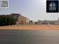 Residential/commercial land for sale in Al Muwaihat 1, Ajman, three streets, behind Salem Mall and N