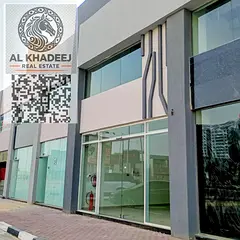 Shops for rent in Al Hamidiya on a main road. Sizes 28, 44, and 47 sqm. Suitable for retail, offices