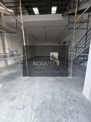 Warehouse complex in Ajman Al Jurf 3, 3000 sqft mezzanine, 62 kVA power, 12m height, dual road access, annual rent AED 175k.