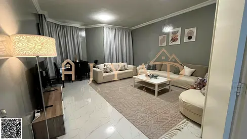 For sale: luxury apartment in Al Khor Towers Ajman, 2 bedrooms, spacious living room, maid's room with bath, 3 bathrooms, 2 balconies, 1800 sq ft