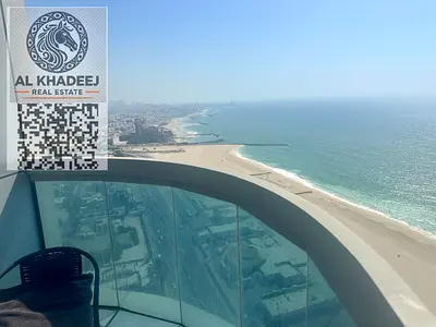 Luxury hotel-style apartment with a direct sea view in Ajman Corniche Tower. 2 bedrooms, hall, 3 bathrooms, equipped kitchen, fully furnished. Rent AE