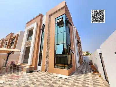 Villa for sale in Al Muwaihat 3, Ajman. Modern design. The villa includes 5 master bedrooms, a living room with a bathroom, 2 main halls, and a maid's