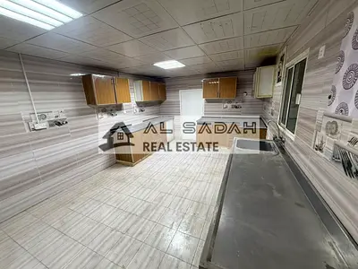 A house for rent, divided into two sections. The first section has 4 bedrooms, a living room, a majlis (formal sitting room), a kitchen, and 3 bathrooms. The second section has 2 bedrooms, a living ro