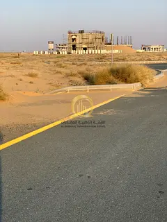 Investment opportunity in Rawdat Al Qurt: Prime commercial land for sale on a 24-meter wide street,