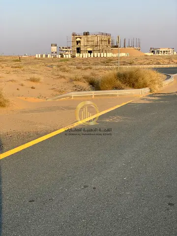 Investment opportunity in Rawdat Al Qurt: Prime commercial land for sale on a 24-meter wide street, measuring 6595 square feet.