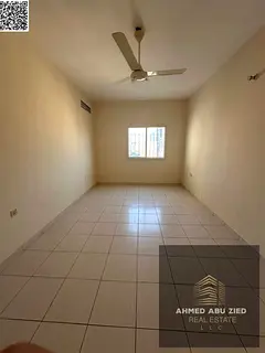 A spacious two-bedroom apartment with a living room and balcony in a prime location in Al Nuaimiya,