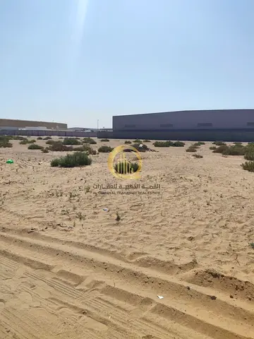 For sale: large corner plot in Al-Sajaa Industrial Area. Land area: 150,000 square feet. Excellent location with entry and exit from the UAE border.