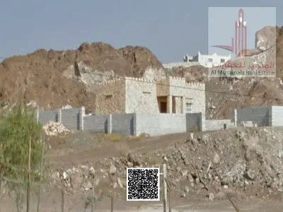 A plot of land for sale in Ajman, Al Manama, Block 2. The land is on two streets, measuring 576 square meters (6200 square feet). It has a building pe