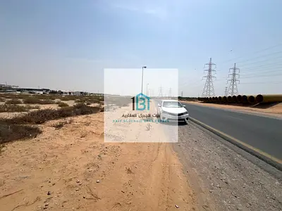 🏢 للبيع – أرض تجارية في الحنو (على شارع العابر مباشرة)  📐 المساحة: 77,000 قدم مربع
