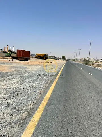 For sale: a plot in the UAE Industrial City in Al-Sajaa, on Street 97. Excellent location, directly next to Al-Qaria Auction and scrap yard for cars