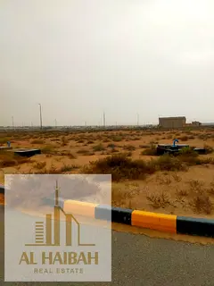 Commercial land for sale in the Muwailih Commercial Area – Al-Falah Camp, in a prime location near