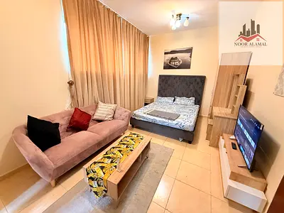 Sharjah Al Khan Furnished studio with second hotel furniture, occupant, large area, room, separate kitchen, bathroom, and large window with sea view.