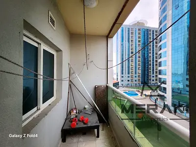 شقة مميزة للبيع في أورينت تاورز عجمان بإطلالة مباشرة على المسبح والحديقة بسعر 450 ألف