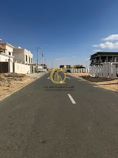 For sale: residential land in Al Houshi, Al Badia District, Sharjah. Area of 10,000 sq.ft on an 18-m