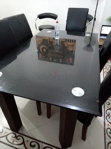 Black dining table urgent selling with 5 chairs included  urgent