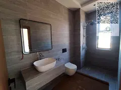 The villa is located in Al Helio 2, Ajman, a quiet and highly sought-after residential area known fo