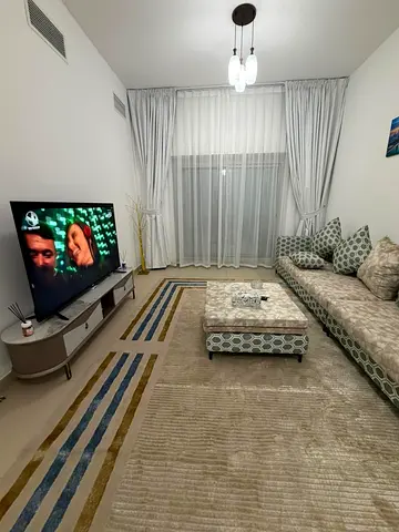 For rent in Ajman, first tenant, Al Nuaimia, next to Han Cafe. Two bedrooms and a living room with a large space, 2 balconies, 3 bathrooms + parking c