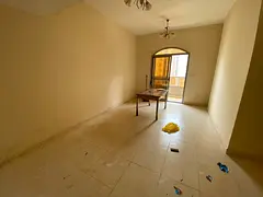 Golden opportunity for annual rent in Ajman: Two bedrooms, a living room, a balcony, and parking ins