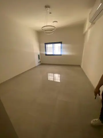 For annual rent in Sharjah, specifically in Al Majaz 2 area: two bedrooms, a living room, two bathrooms, a balcony, and split air conditioning. Excell