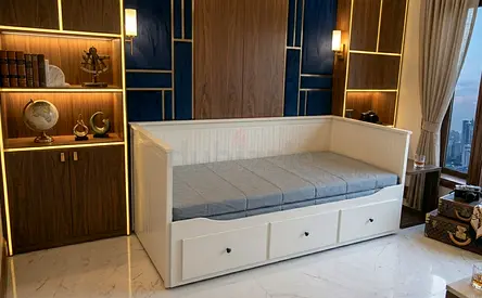 Daybed with Storage: White wooden daybed featuring three smooth drawers and a soft grey cushion, per