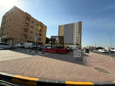 **English Translation:** A prime plot of land for sale in **Al Nuaimiya 1**, strategically located **directly opposite Al Hikma School**, offering hi