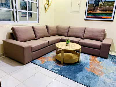 Spacious L-Shaped Sofa and Colorful Rug Set
