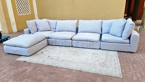 Modular feather filled sofa with footstool