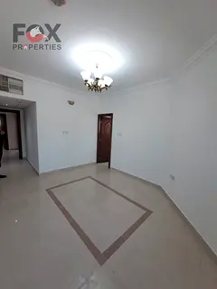 A two-bedroom apartment with a living room for annual rent in the Rumaila area, featuring a balcony,