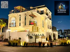 In Al Bahia area, Ajman, a corner villa with two floors and a roof, fully air-conditioned, freehold