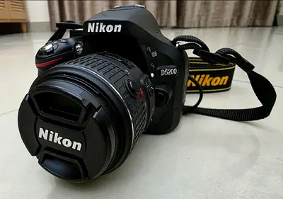 Nikon D5200 DSLR Camera with 18-55mm VR2 Lens and Accessories for Sale in Excellent Condition