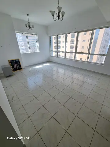 For rent in Al Taawun: 3BR + hall with maid room, sea view balcony, gym & pool, prime location close to services and transport.
