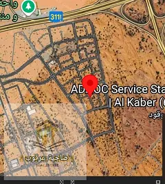 Commercial corner land opposite the garden for sale in Arqoub, freehold, all nationalities
