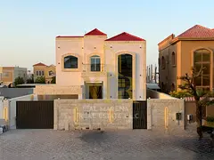 A luxurious villa with a modern design, located in Al Muwaihat 1, featuring spacious areas and high-