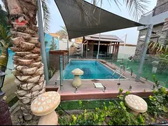Luxury villa for sale in Al Rawda 3 Ajman, corner on two streets, private pool and garden, 5 master