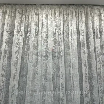 Tulle with jacquard weave or guipure with a dense floral or plant pattern.