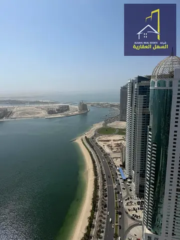 For sale, an apartment with a panoramic view of Al Khan Lake, in an excellent location