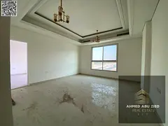 3BR hall apartment, first tenant in Al Mowaihat 3, Ajman. Free month, balcony, central AC, built-in