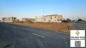 For sale, two adjacent corner plots in Al Helio 1, featuring a strategic location on two streets wit