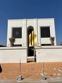 A modern villa in Al-Hawshi completely clad in stone.