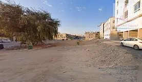 Land for sale in Al Muwaihat area, prime location, second plot from Sheikh Ammar Street. Land area: