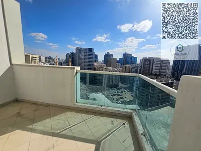 Two-bedroom apartment with living room for sale in Ajman One Towers, featuring a city view, built-in wardrobes, and parking.