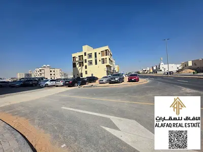 Corner residential–commercial plot on two streets in Al Amerah, second row from the main road, very close to Sheikh Mohammed Bin Zayed Road, a rare in