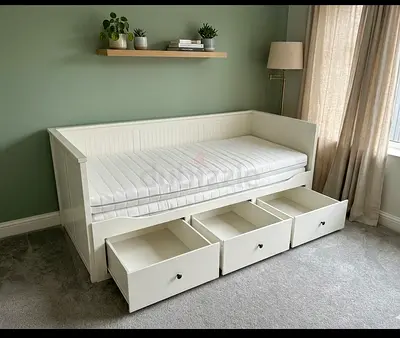 Elegant white daybed with large drawers for storage. Great for organizing blankets, pillows, and mor